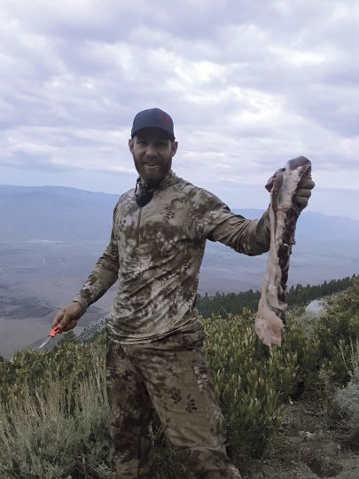 After the shot, and with darkness closing in fast, the young hunters had to quarter the deer and lash it to pack frames for the seven-mile hike back to their truck. Cody holds the backstrap of the big buck before stashing it on his pack.